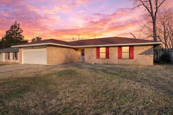 a view of a house with a backyard