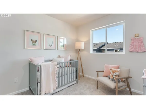a living room with furniture and a baby crib