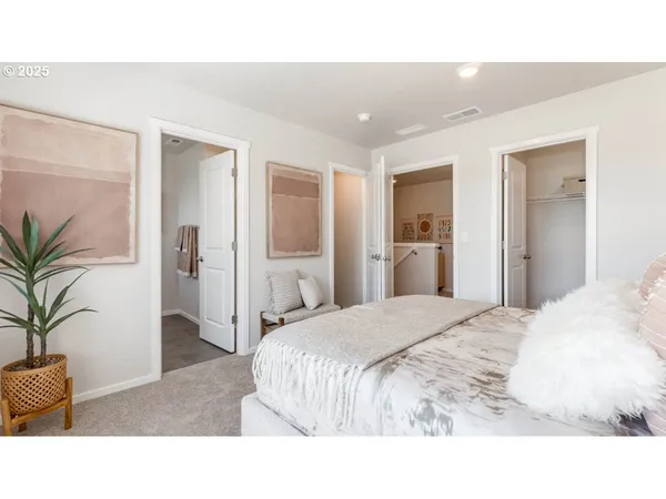 a living room with a bed and a potted plant