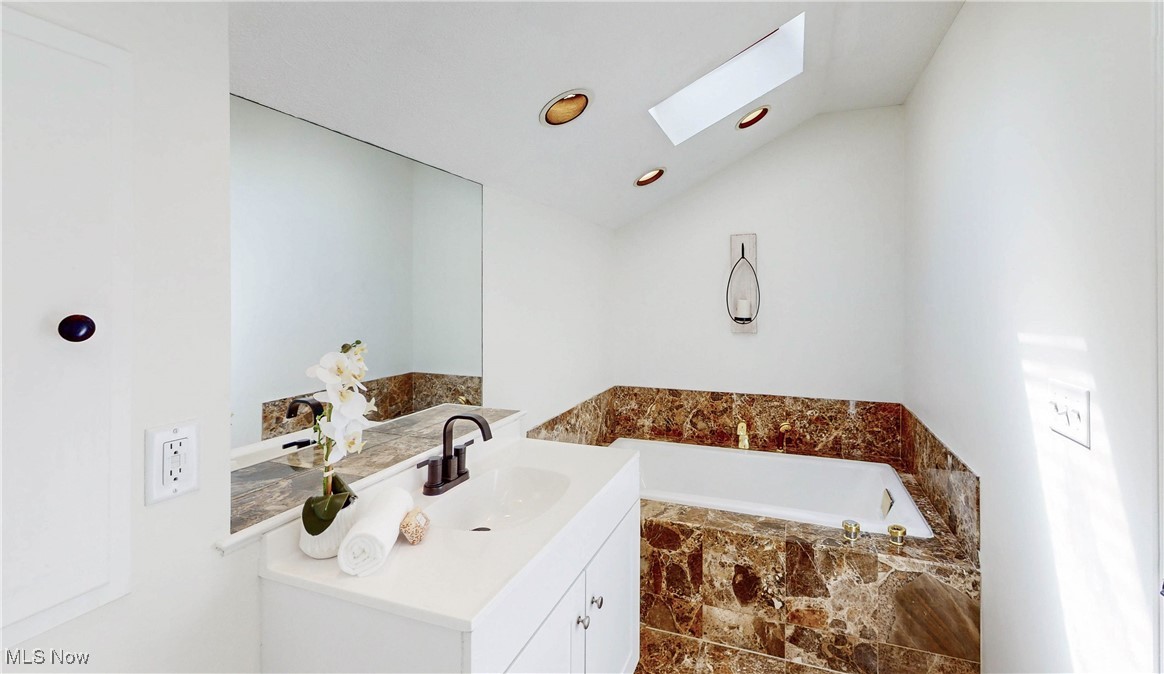 260 Sand Run Road Akron, OH 44313 - Photo 31 of 48 Full bath with a bath, vaulted ceiling with skylight, and vanity