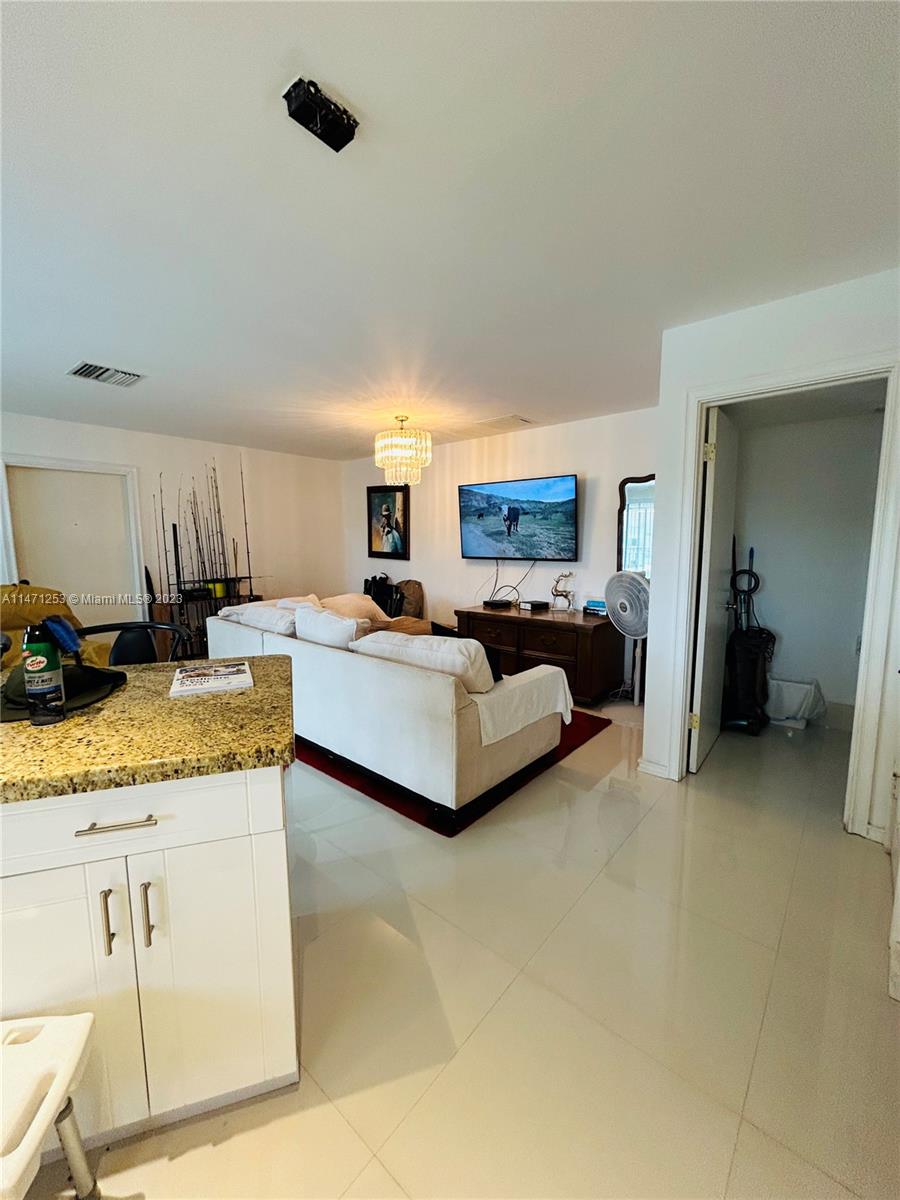 22795 Southwest 66th Avenue, Unit 205 Boca Raton, FL 33428 - Photo 11 of 33 a living room with granite countertop furniture and a kitchen