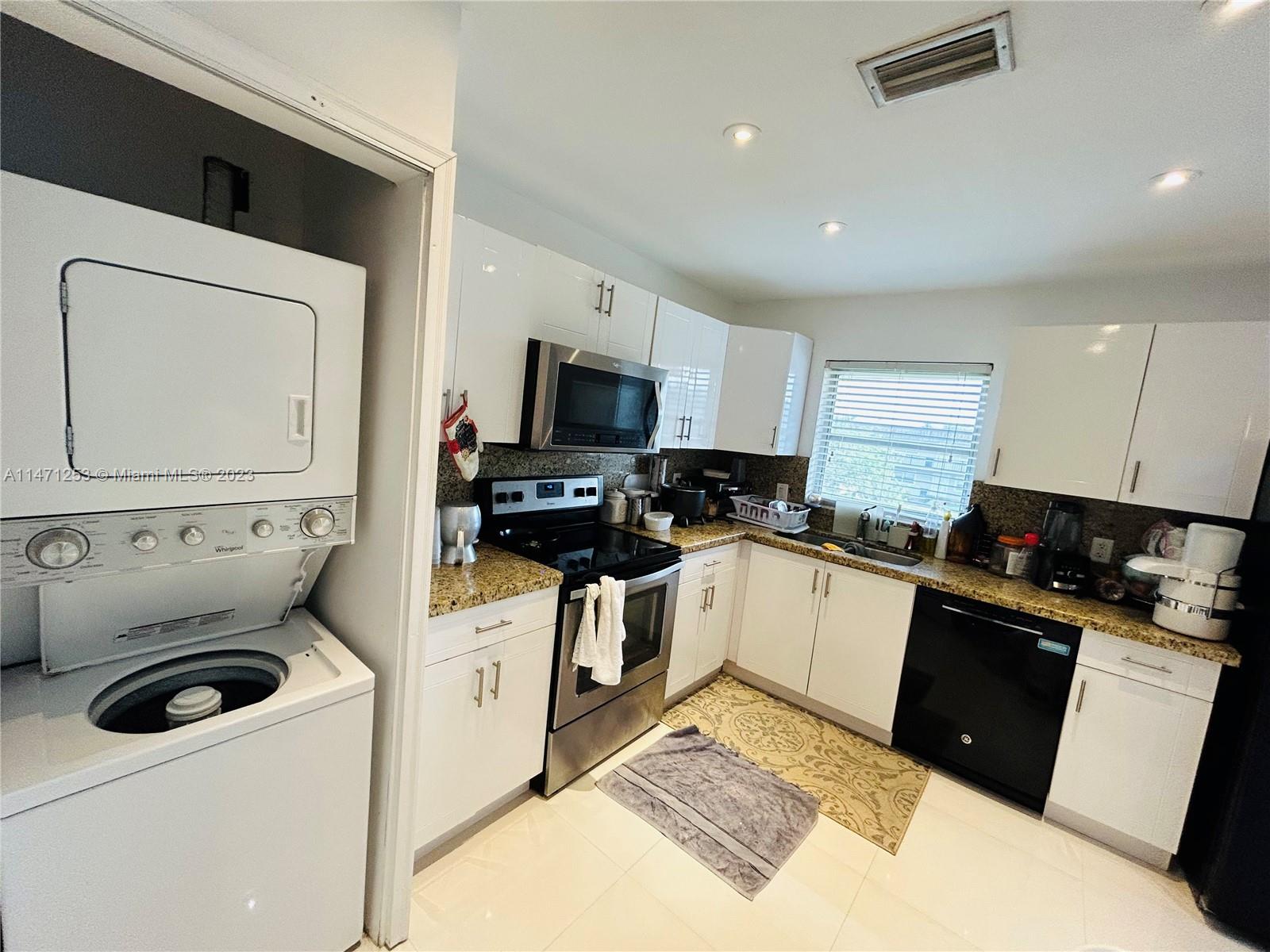 22795 Southwest 66th Avenue, Unit 205 Boca Raton, FL 33428 - Photo 14 of 33 a kitchen with a sink a stove and refrigerator