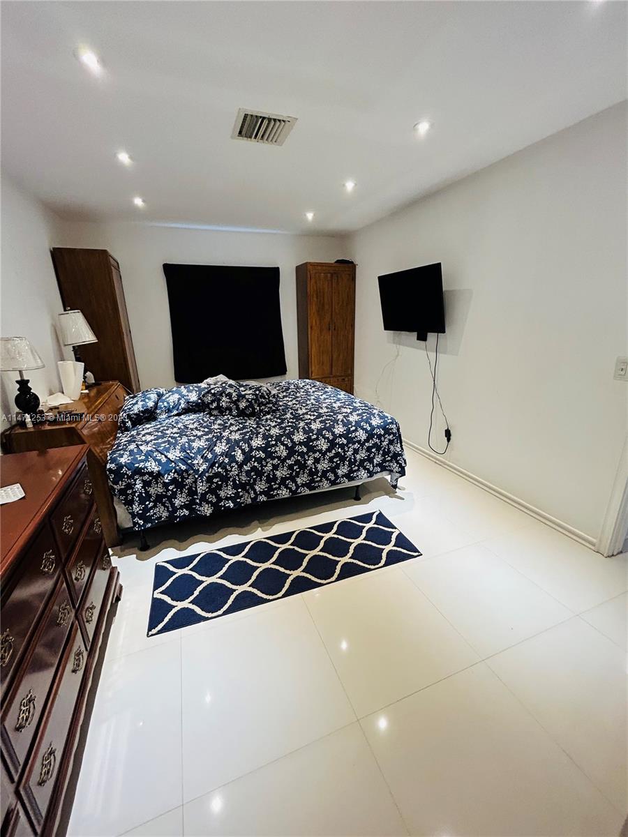 22795 Southwest 66th Avenue, Unit 205 Boca Raton, FL 33428 - Photo 17 of 33 a bedroom with a bed and a view of kitchen