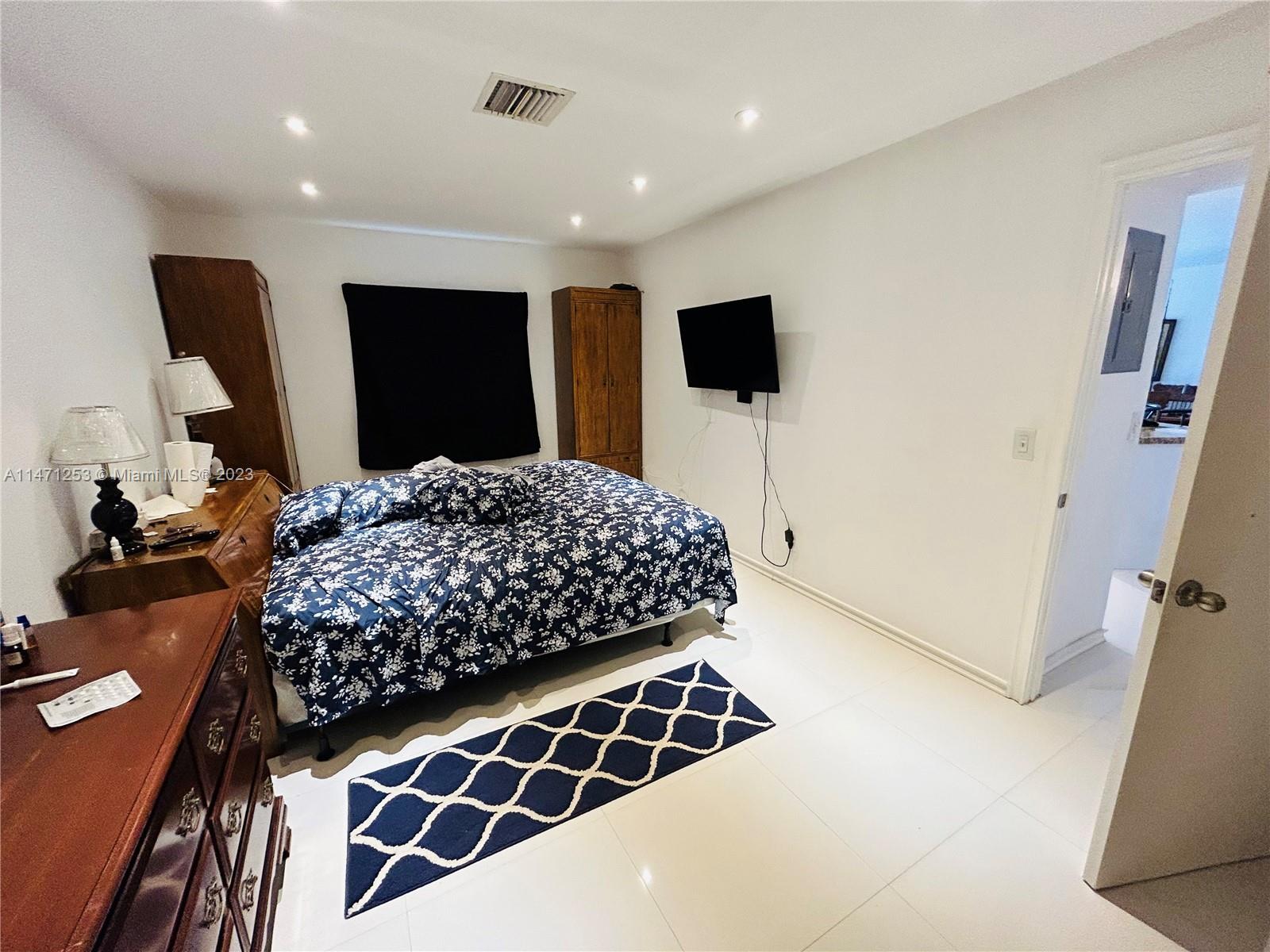 22795 Southwest 66th Avenue, Unit 205 Boca Raton, FL 33428 - Photo 18 of 33 a bedroom with a bed and a television
