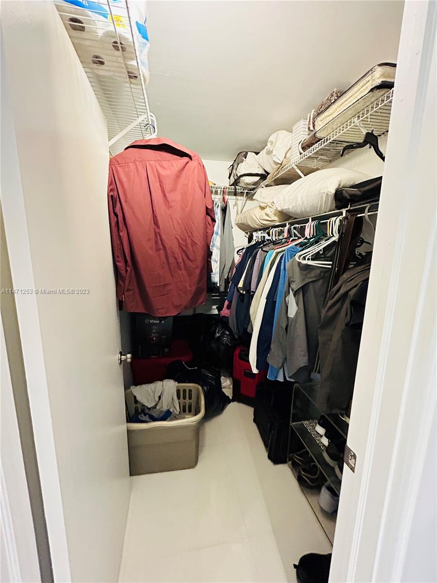 22795 Southwest 66th Avenue, Unit 205 Boca Raton, FL 33428 - Photo 20 of 33 a view of walk in closet with clothes and shoes