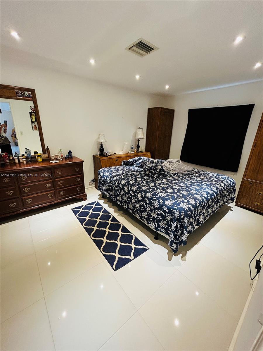 22795 Southwest 66th Avenue, Unit 205 Boca Raton, FL 33428 - Photo 21 of 33 a bed room with a bed and a television