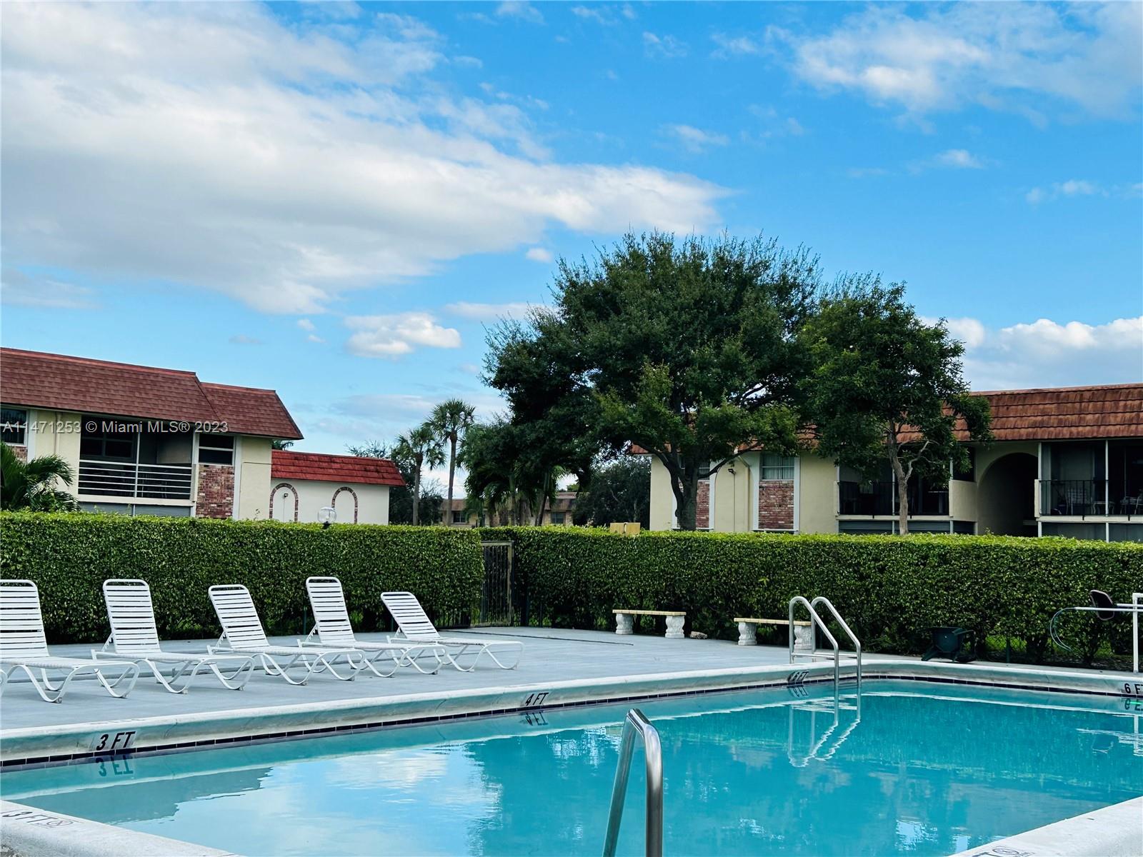 22795 Southwest 66th Avenue, Unit 205 Boca Raton, FL 33428 - Photo 28 of 33 a view of a house with swimming pool and porch