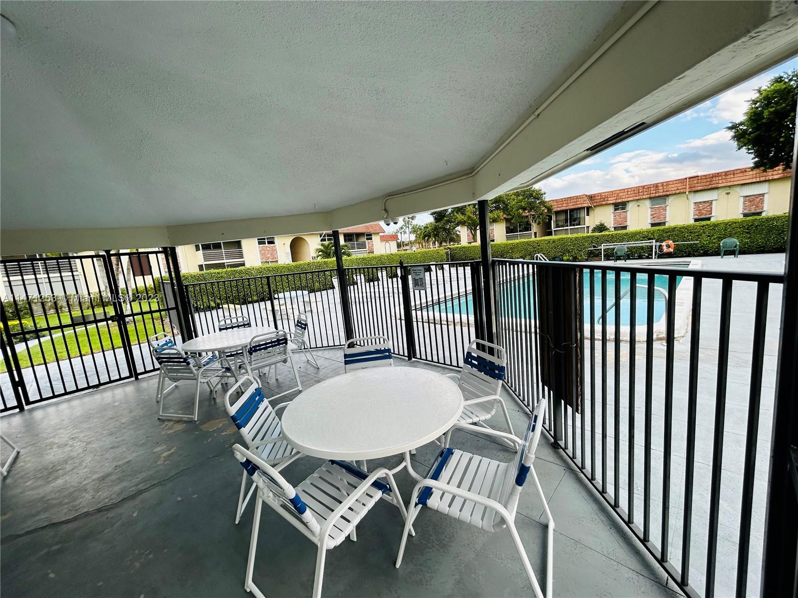 22795 Southwest 66th Avenue, Unit 205 Boca Raton, FL 33428 - Photo 29 of 33 a view of a patio with a table chairs and backyard