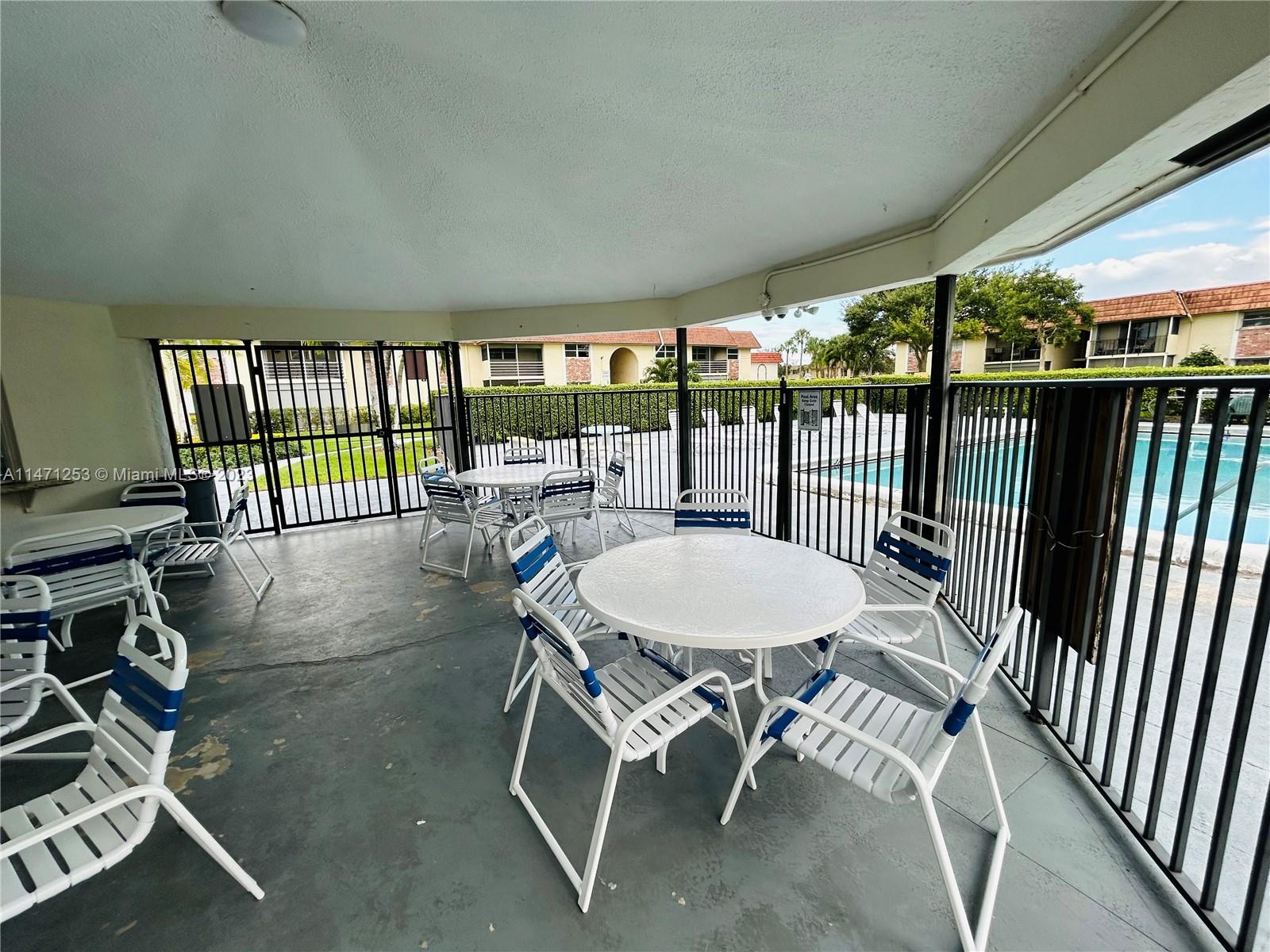 22795 Southwest 66th Avenue, Unit 205 Boca Raton, FL 33428 - Photo 30 of 33 a view of a patio with a table chairs and backyard