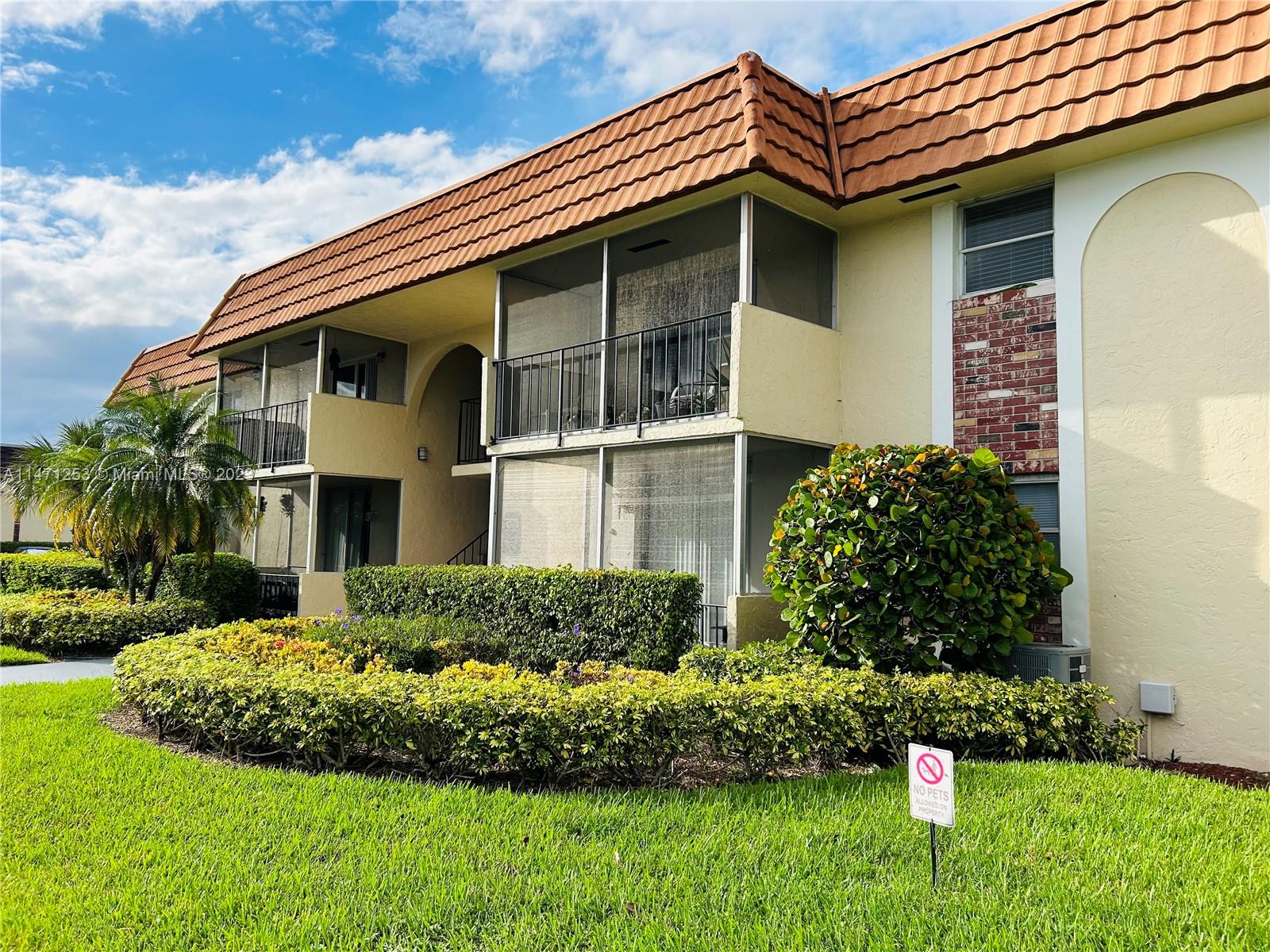 22795 Southwest 66th Avenue, Unit 205 Boca Raton, FL 33428 - Photo 31 of 33 a front view of a house with a yard