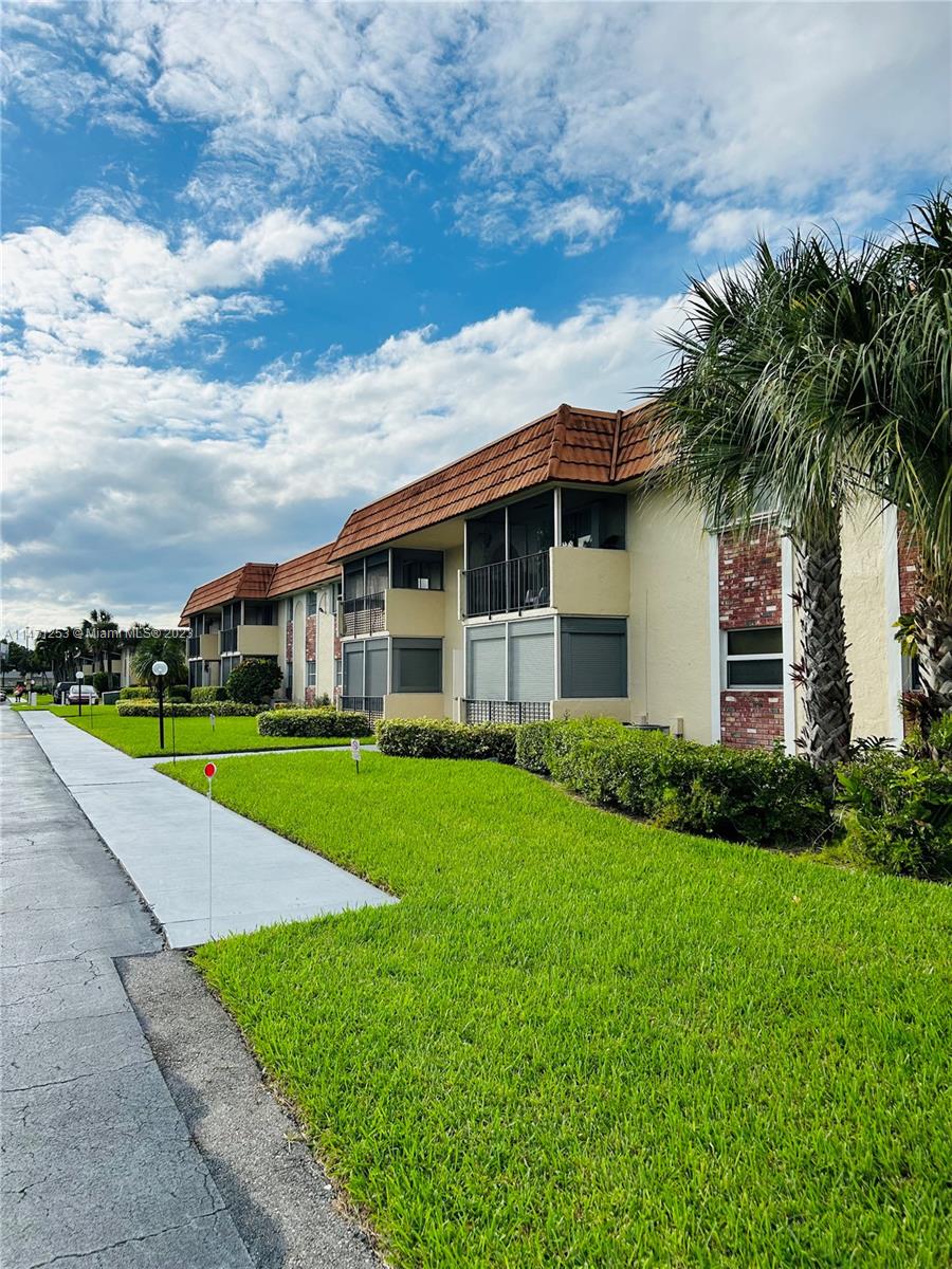 22795 Southwest 66th Avenue, Unit 205 Boca Raton, FL 33428 - Photo 33 of 33 a view of a house with a big yard plants and large trees