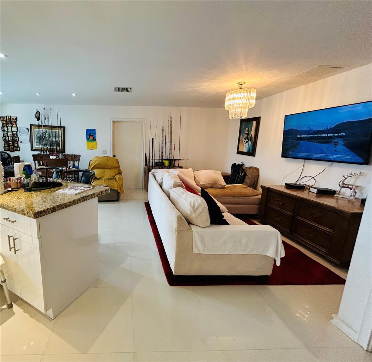 22795 Southwest 66th Avenue, Unit 205 Boca Raton, FL 33428 - Photo 5 of 33 a living room with furniture and a flat screen tv