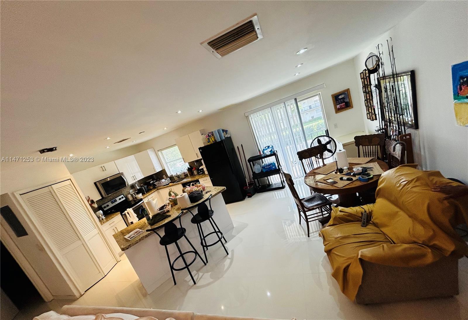 22795 Southwest 66th Avenue, Unit 205 Boca Raton, FL 33428 - Photo 7 of 33 a living room with furniture and a flat screen tv