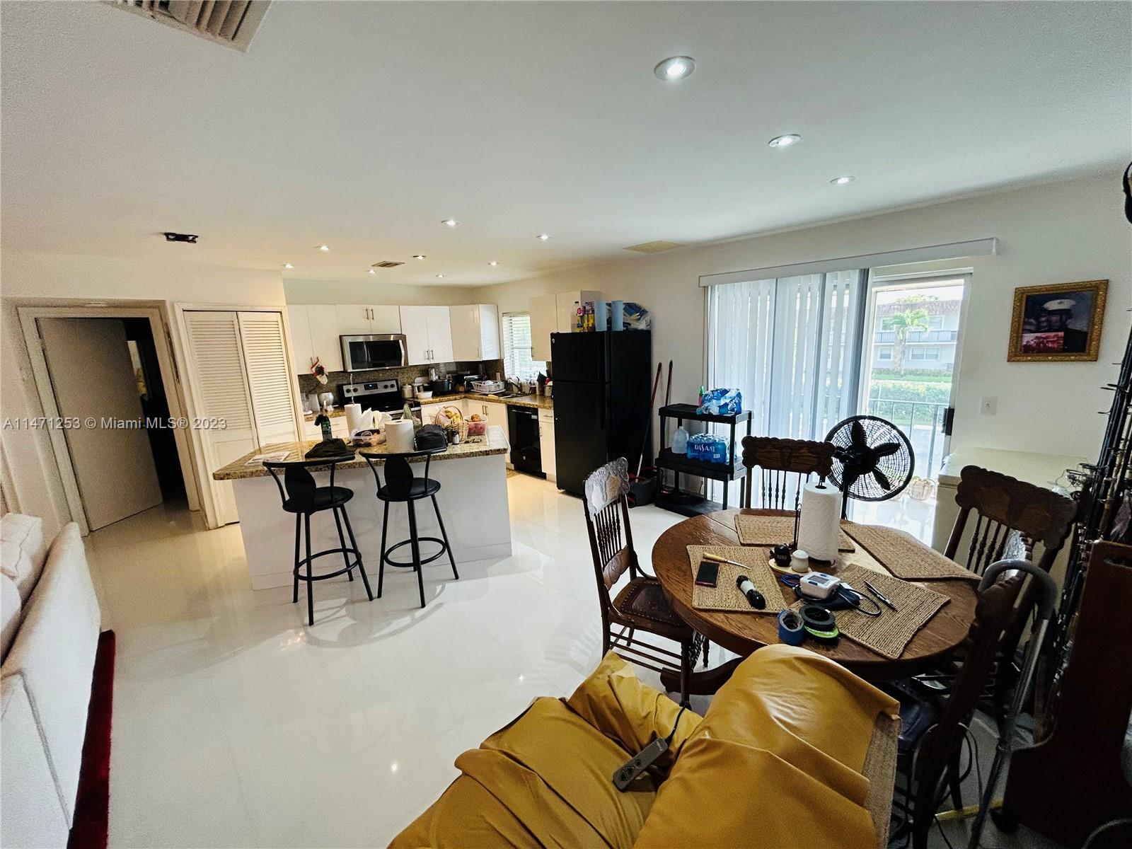 22795 Southwest 66th Avenue, Unit 205 Boca Raton, FL 33428 - Photo 9 of 33 a living room with furniture and a flat screen tv
