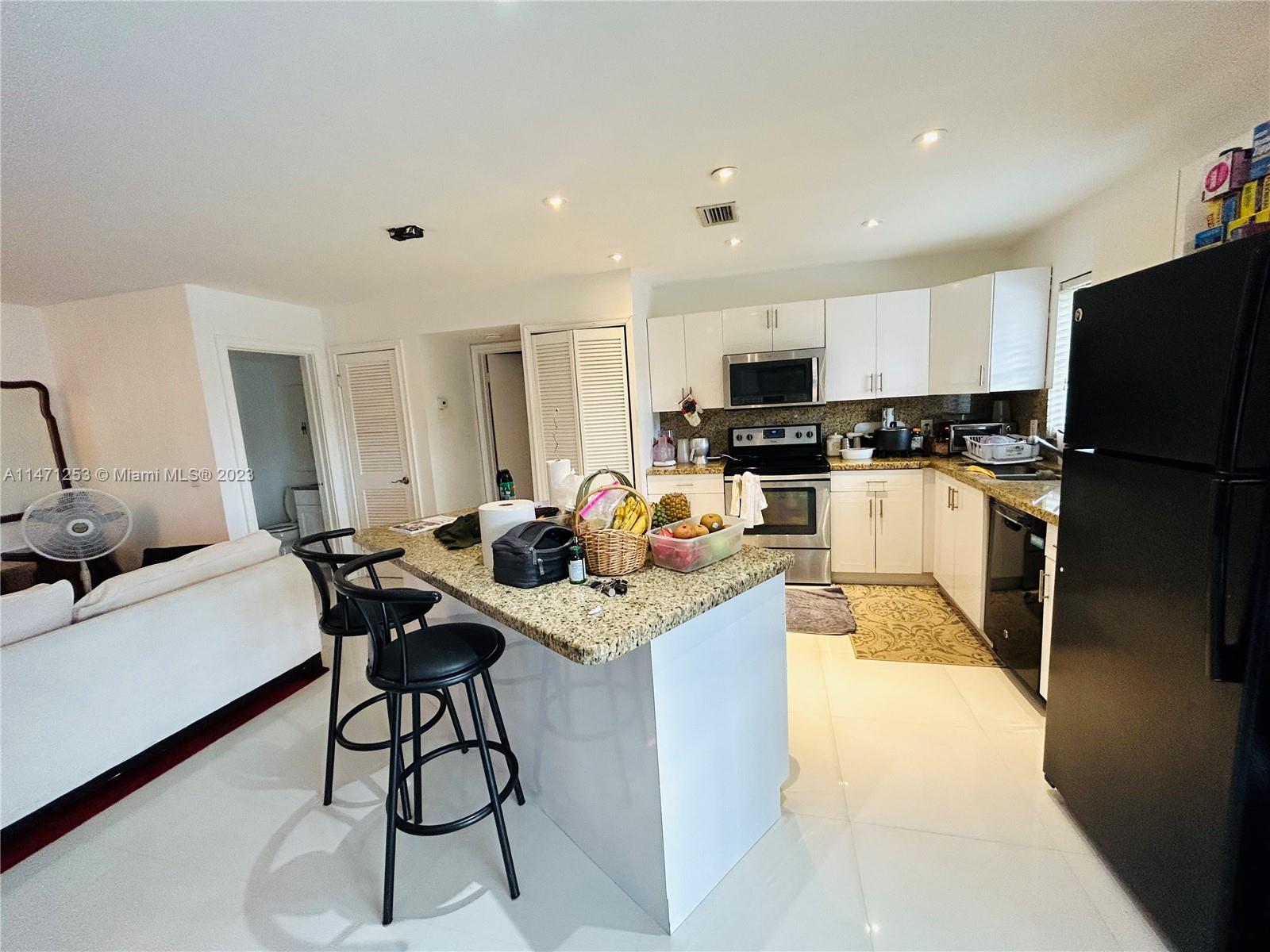 22795 Southwest 66th Avenue, Unit 205 Boca Raton, FL 33428 - Photo 10 of 33 a kitchen with stainless steel appliances granite countertop sink stove refrigerator and cabinets