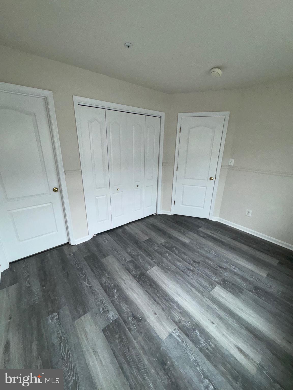 7705 Periwinkle Way, Unit 71 Severn, MD 21144 - Photo 4 of 28 a view of room with window and wooden floor