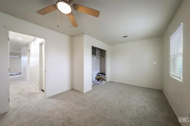 a view of a hallway with bathroom and a bathroom