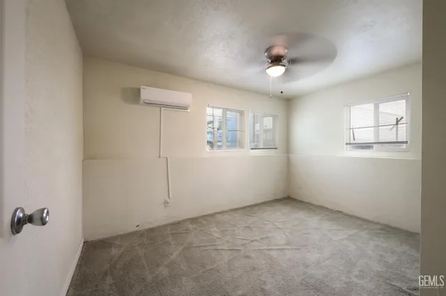 a living room with furniture and a dining table with kitchen view