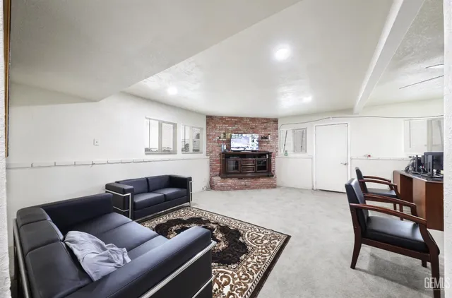 a living room with furniture and a piano