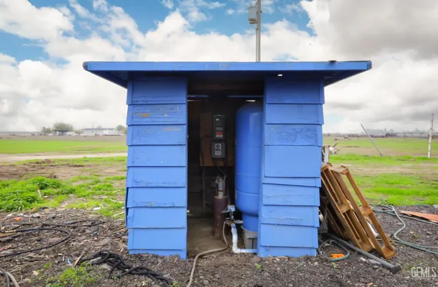 a view of a wooden door with a bench and a yard