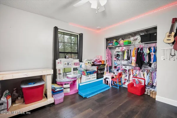 a living room with baby toys and wooden floor