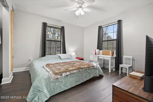 a bedroom with a bed and a flat screen tv