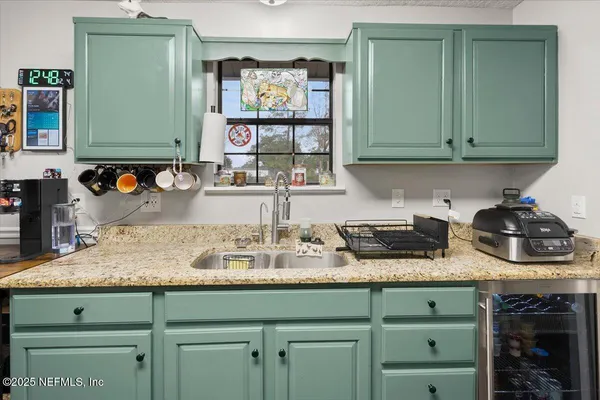 a kitchen with a sink stove and refrigerator