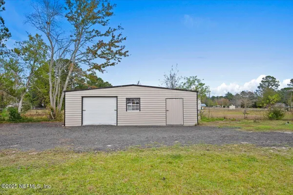 a backyard of a house with table and chairs