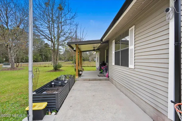 a view of a house with backyard and sitting area