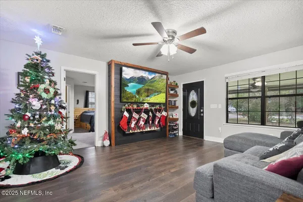 a living room with furniture flowers and a chandelier