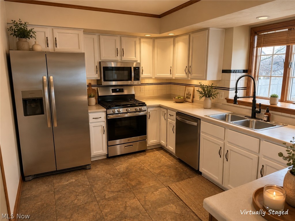 6416 Ridgeview Avenue Youngstown, OH 44515 - Photo 2 of 15 Kitchen featuring white cabinetry, stainless steel appliances, a double basin sink with a matte black gooseneck faucet, light countertops, and wood-finish flooring