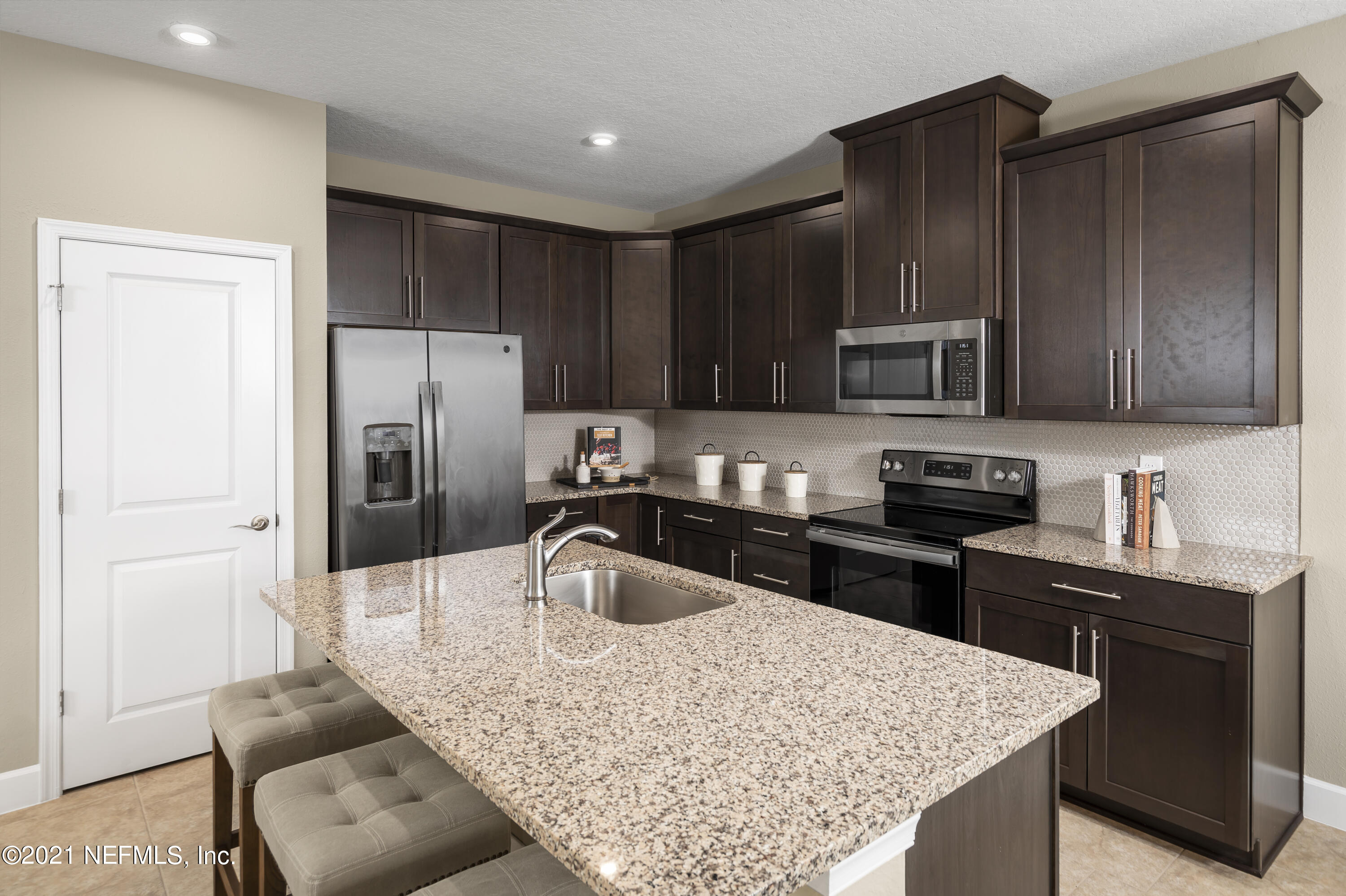 1339 Tan Tara Trail Jacksonville, FL 32221 - Photo 12 of 18 a kitchen with stainless steel appliances granite countertop a sink refrigerator and cabinets