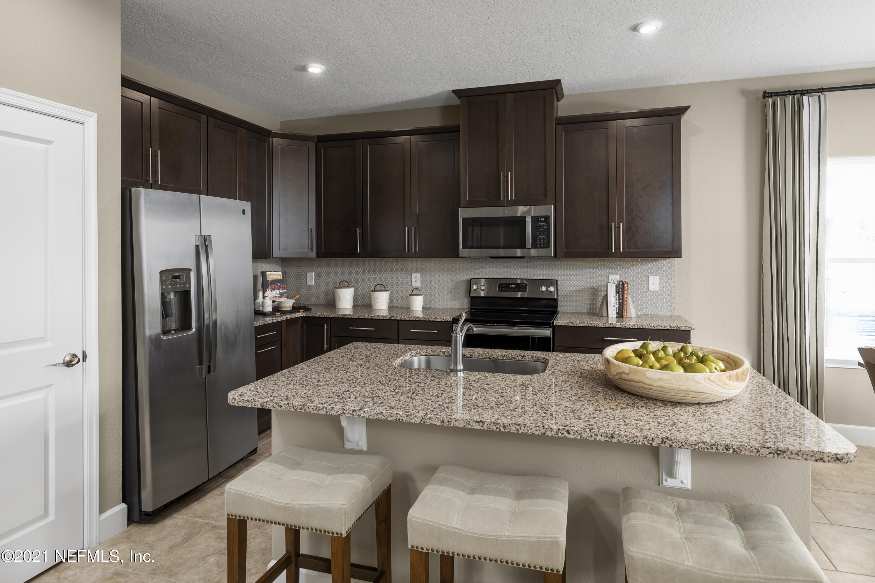 1339 Tan Tara Trail Jacksonville, FL 32221 - Photo 13 of 18 a kitchen with granite countertop stainless steel appliances and wooden cabinets