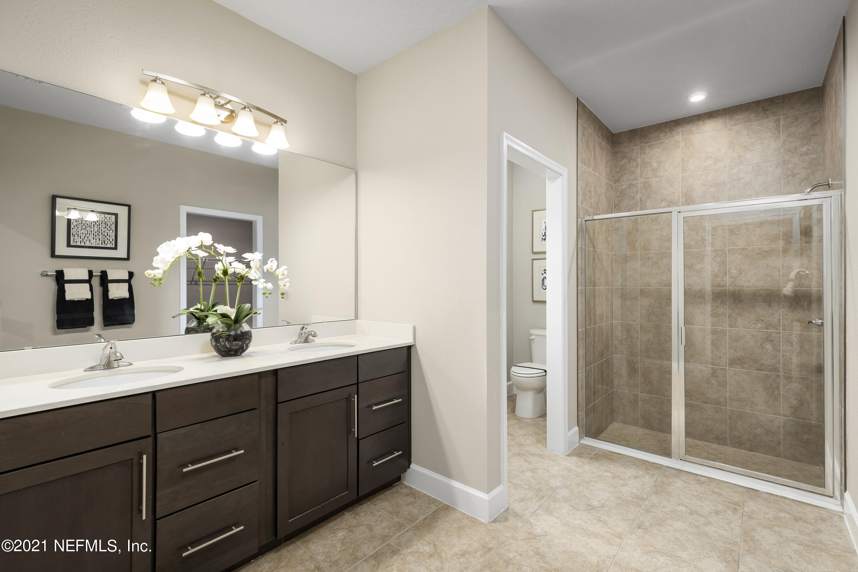 1339 Tan Tara Trail Jacksonville, FL 32221 - Photo 17 of 18 a bathroom with a double vanity sink mirror and shower