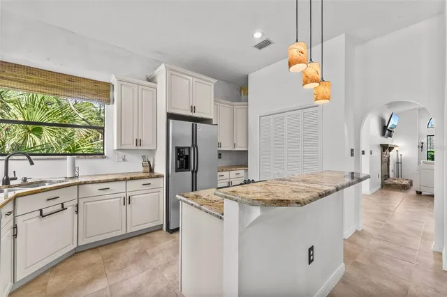 a kitchen with a sink stove and refrigerator