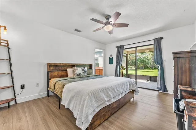 a bedroom with a large bed and a large window