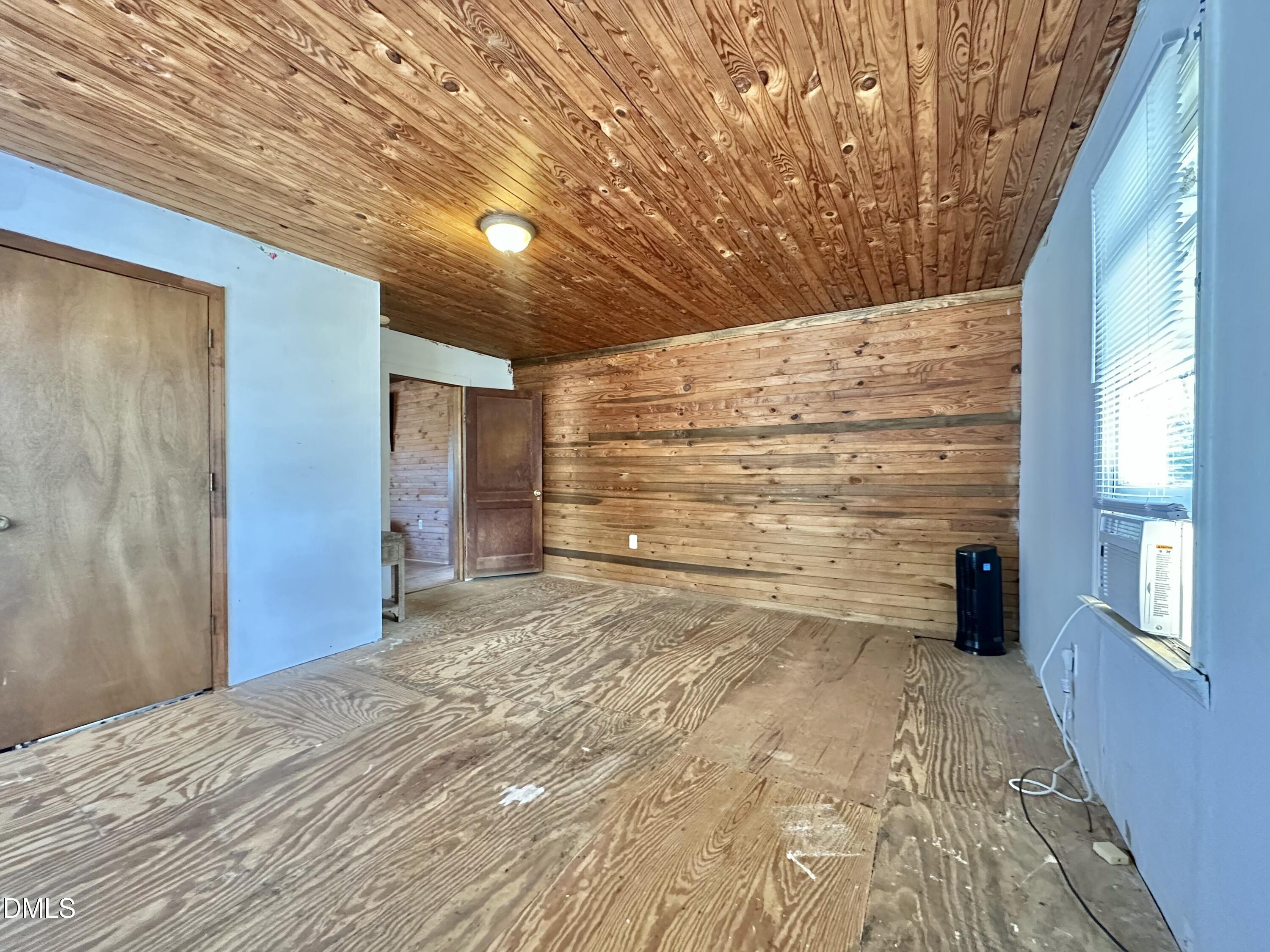 829 Shaw's Pond Road Four Oaks, NC 27524 - Photo 9 of 30 a view of a big room with wooden floor and brick walls
