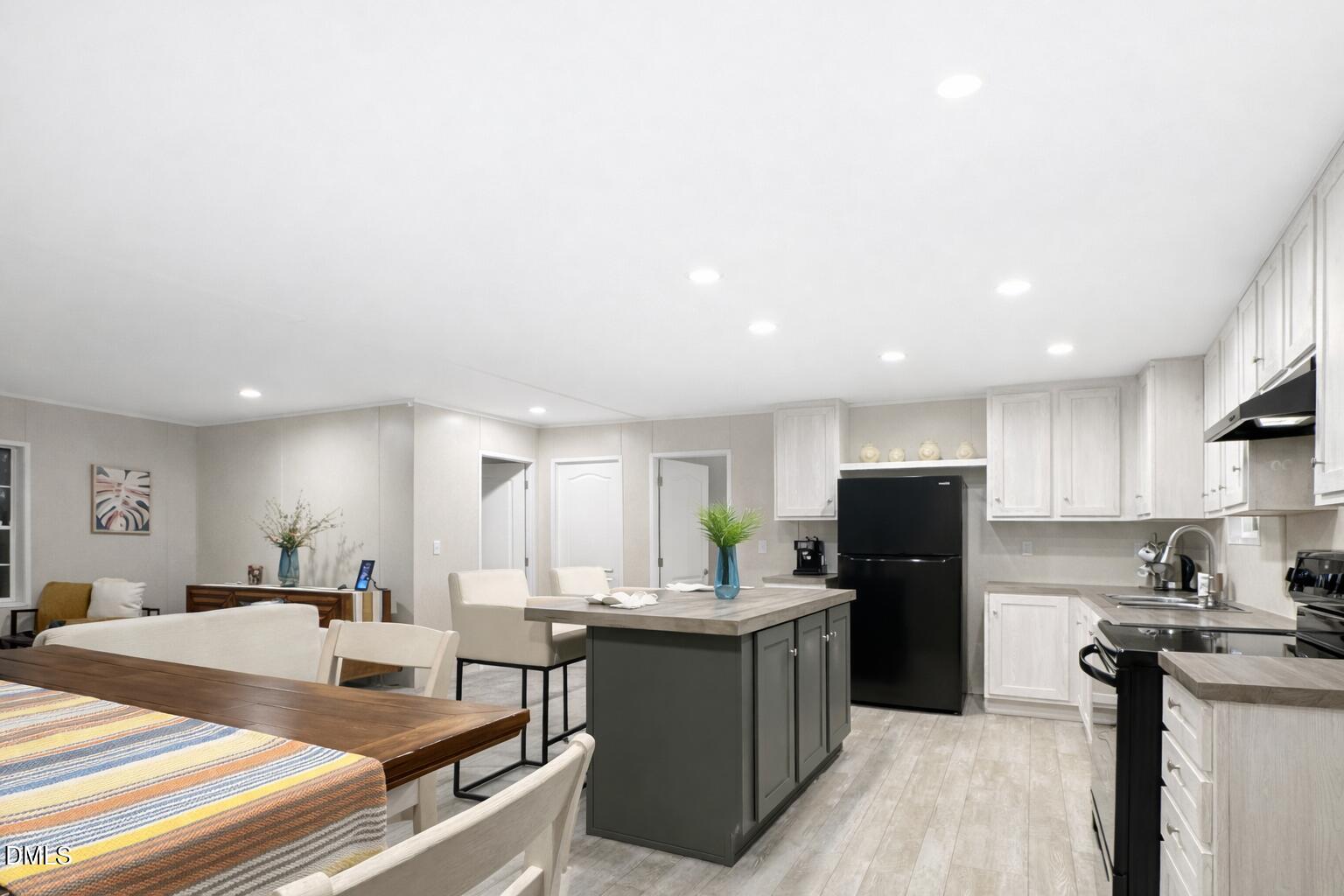 829 Shaw's Pond Road Four Oaks, NC 27524 - Photo 19 of 26 a kitchen with kitchen island a counter top space a sink stainless steel appliances and cabinets