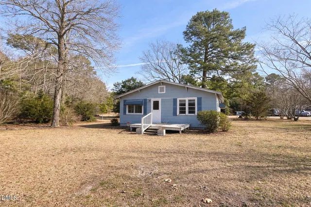 a view of a house with a yard covered in snow