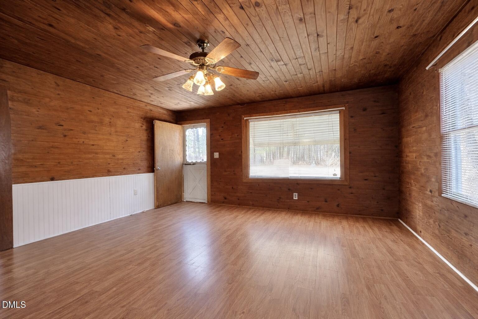829 Shaw's Pond Road Four Oaks, NC 27524 - Photo 8 of 30 a view of an empty room with a window and wooden floor