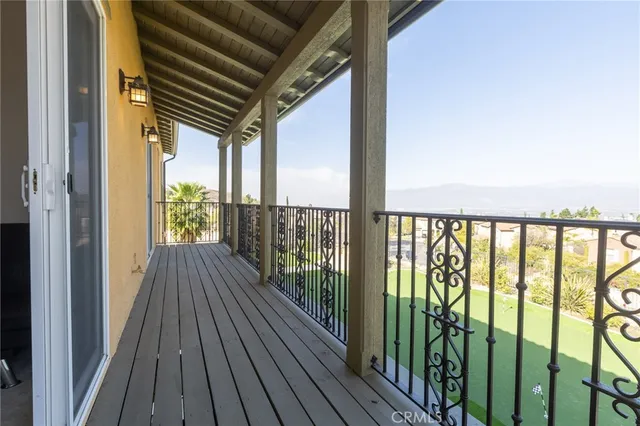 a view of a balcony with wooden floor