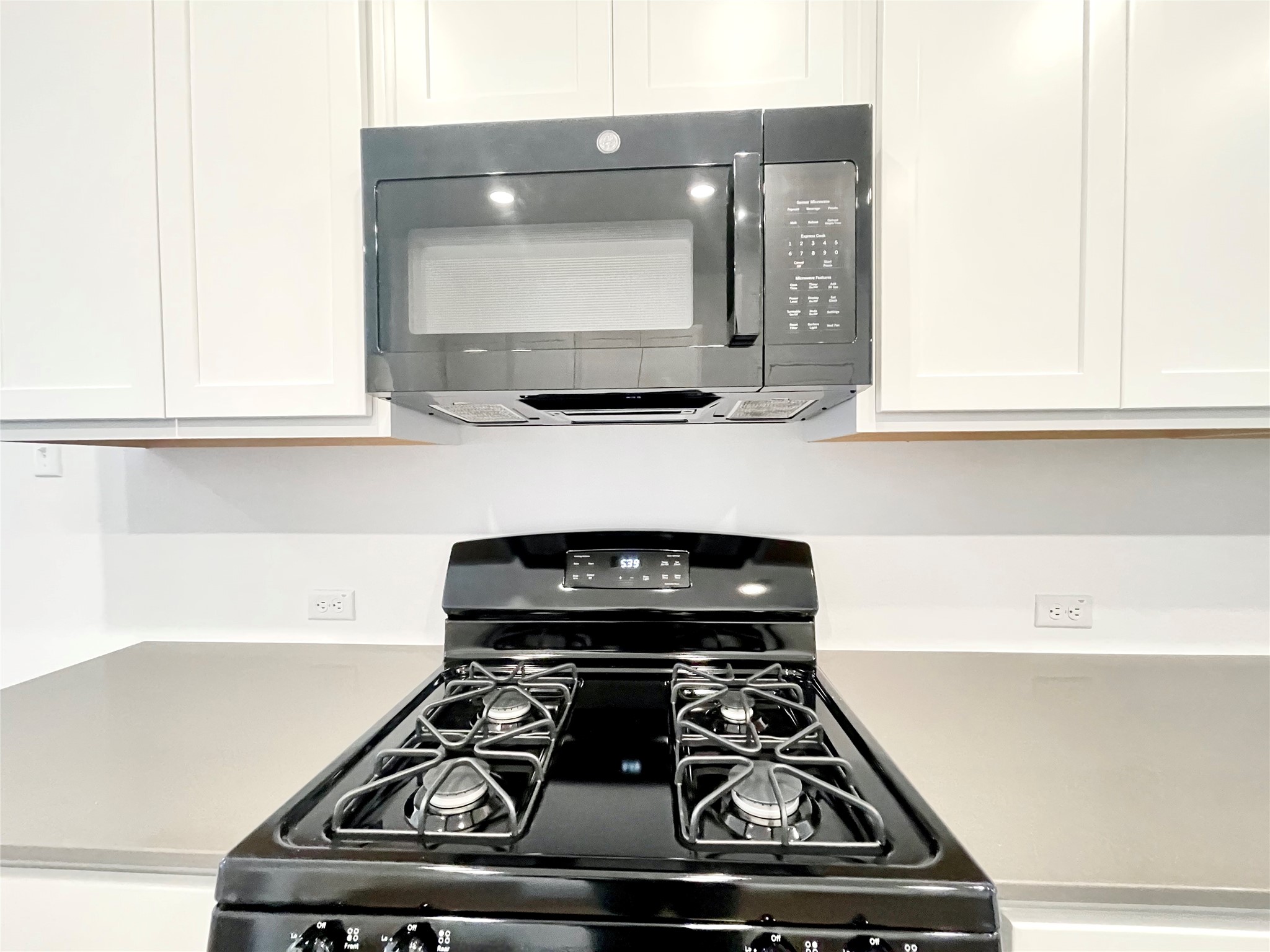 305 Milliner Loop Hutto, TX 78634 - Photo 14 of 36 a stove top oven sitting inside of a kitchen