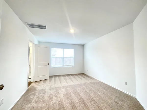 a spacious bathroom with a shower a sink and a mirror