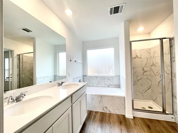 a bathroom with a double vanity sink and mirror