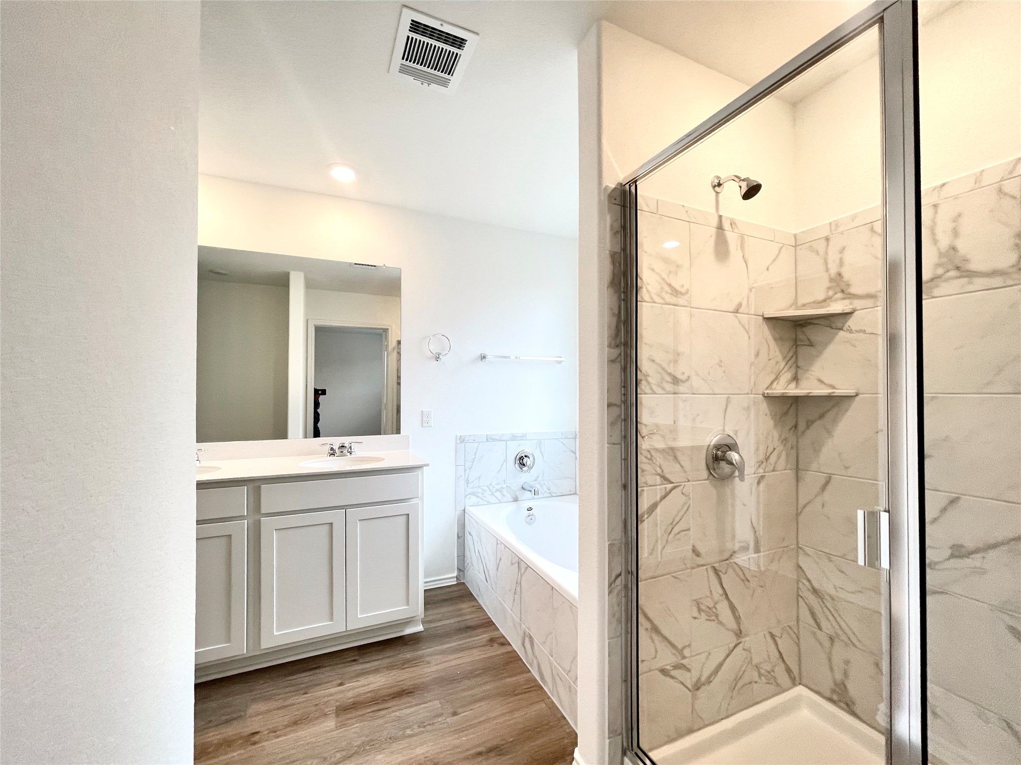 305 Milliner Loop Hutto, TX 78634 - Photo 23 of 36 a bathroom with a double vanity sink and mirror