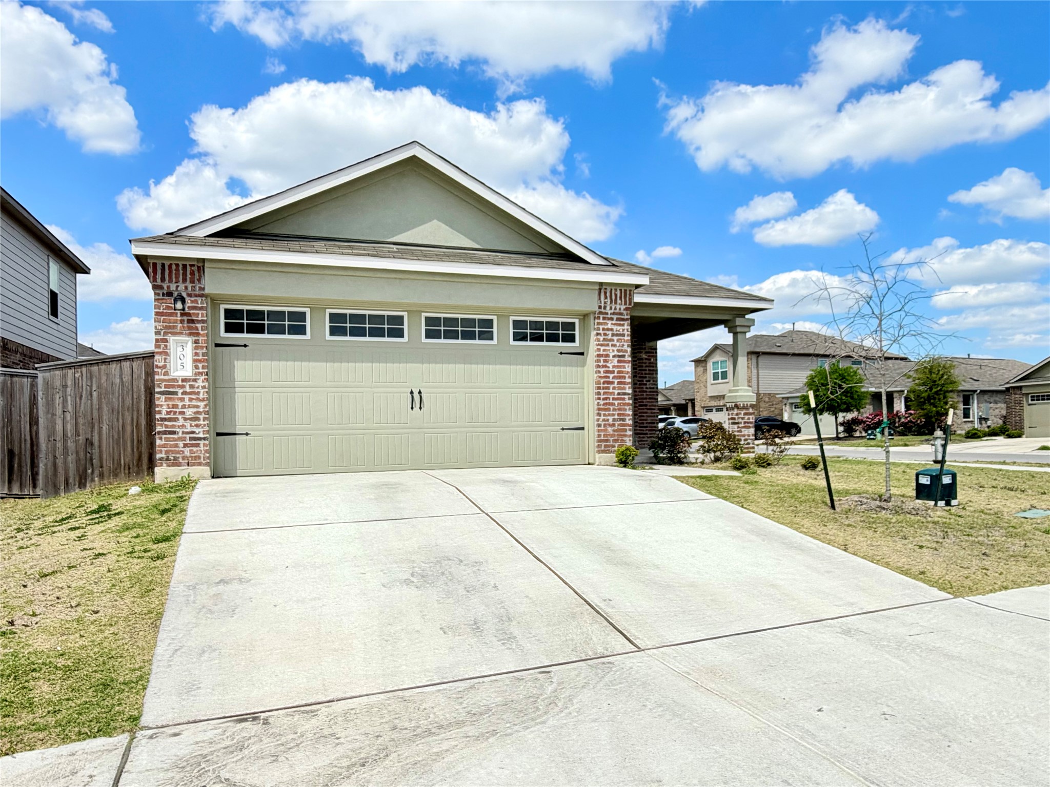 305 Milliner Loop Hutto, TX 78634 - Photo 3 of 36 a front view of a house with a garden