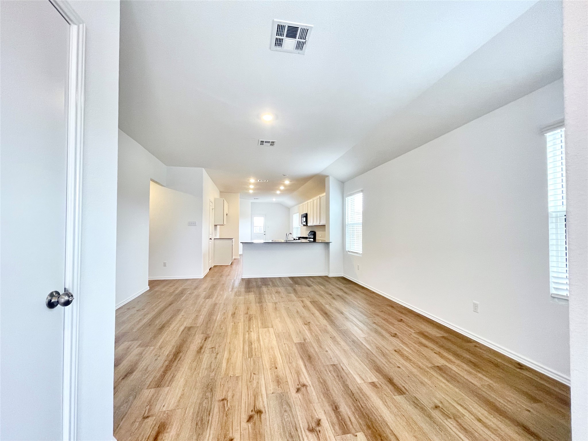 305 Milliner Loop Hutto, TX 78634 - Photo 7 of 36 a view of empty room with wooden floor