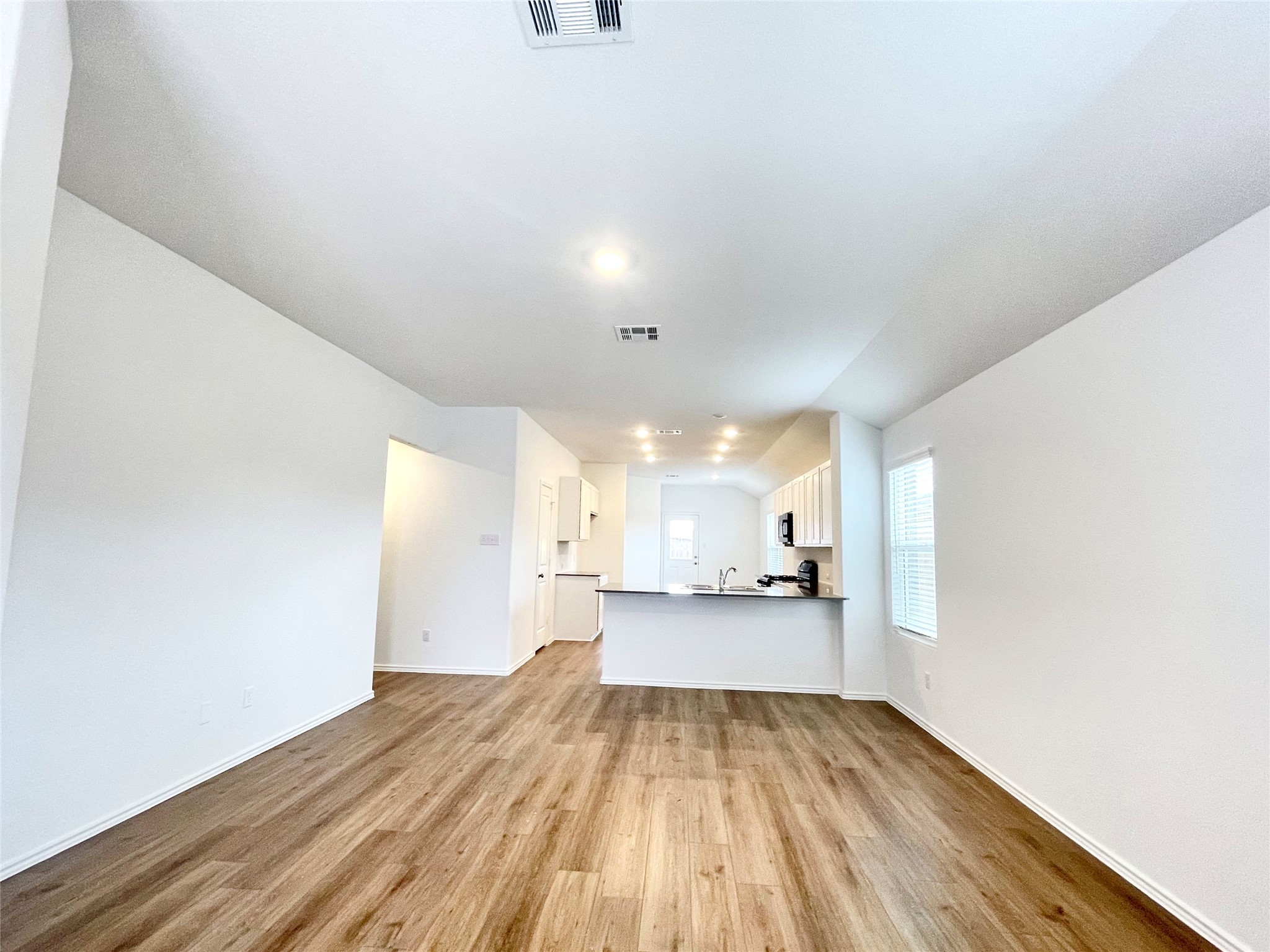 305 Milliner Loop Hutto, TX 78634 - Photo 8 of 36 a view of a kitchen with a sink and wooden floor