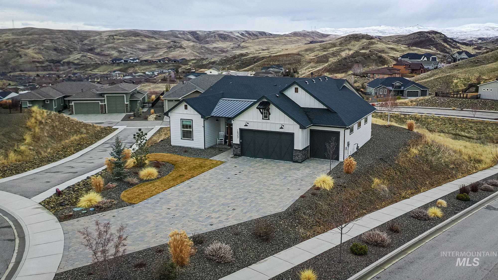18357 North Burnt Car Way Boise, ID 83714 - Photo 1 of 48 Aerial view of residential area with mountains