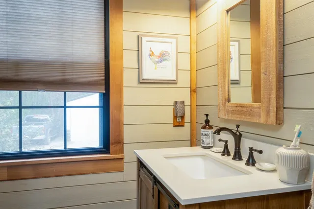 a bathroom with a toilet and a picture on the wall